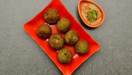 Falafel is a deep-fried ball or patty; it is a Middle Eastern cuisine made from ground chickpeas, broad beans, or both; generally served with hummus; is also a Middle Eastern dip - spread dish made from cooked, mashed chickpeas blended with tahini, lemon juice, garlic, olive oil, parsley and paprika