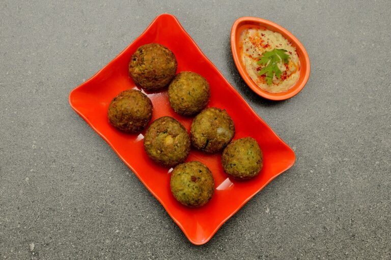 Falafel is a deep-fried ball or patty; it is a Middle Eastern cuisine made from ground chickpeas, broad beans, or both; generally served with hummus; is also a Middle Eastern dip - spread dish made from cooked, mashed chickpeas blended with tahini, lemon juice, garlic, olive oil, parsley and paprika